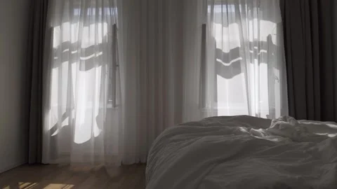 Soft morning sunlight casting shadows on wrinkled cotton bedsheets Stock Footage 313256047