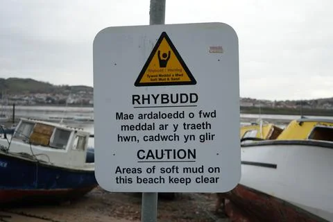 Soft Mud Warning Sign In Welsh And English At Conwy, North Wales Beach With Stock Photos
