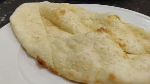 Soft naan ruti bread served warm for cultural dining experience Stockbeeldmateriaal 320635961