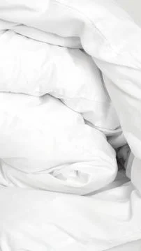 Soft neutral bed linen in minimal hotel room for peaceful relaxing sleep Stock Photos