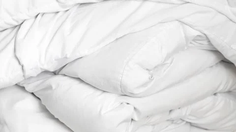 Soft neutral bed linen in minimal hotel room for peaceful relaxing sleep Stock Photos