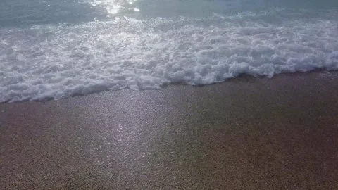 Soft Ocean Wave Foam Lapping on Sandy Beach Shore Stock Footage 326305597