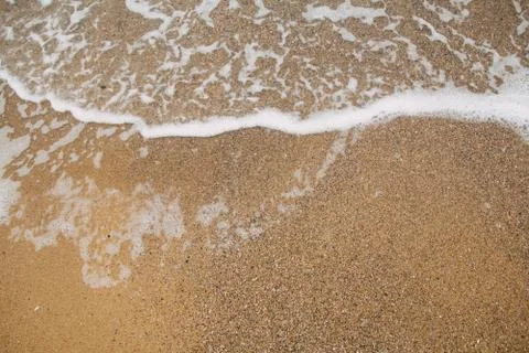 Soft ocean wave on sandy beach, background Stock Photos