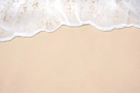 Soft ocean wave on tropical sandy beach in summer background with copy space Stock Photos