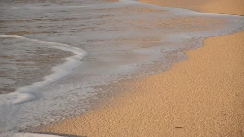 Soft ocean waves with foam on the sandy beach at summer. Golden sand at sunset Stock Footage 141293888