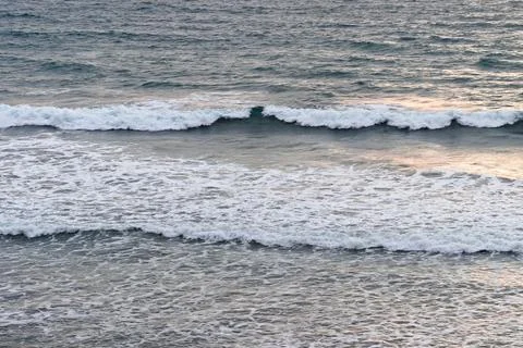 Soft ocean waves roll toward the shoreline Stock Photos