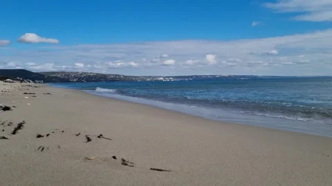 Soft Ocean Waves Rolling on Sandy Beach under Clear Blue Sky 4K Stock Footage 319008938