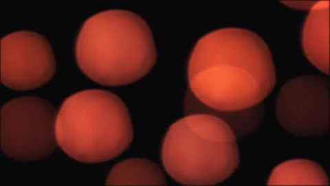 Soft orange bokeh lights float on a dark background, creating a warm abstract Video stock 332801912