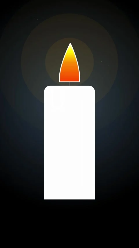 Soft orange flame glowing on pillar candle against deep dark backdrop. Stock Footage 344936874