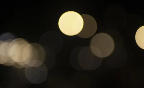 Soft, out-of-focus warm lights glow against a dark background, forming layere Ilustração Stock