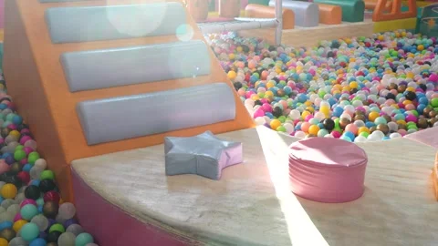 Soft padded playground area with bright sun rays shining across foam steps Stock Footage 321232357