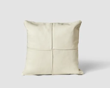 Soft padded sofa cushion made of white leather patches Stock Photos