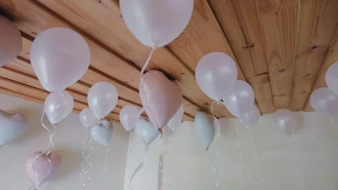 Soft pastel balloons floating under wooden ceiling decor Stock Footage 321517704