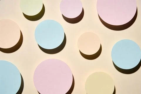 Soft pastel circles casting shadows on a warm beige background, abstract desi Stock Photos