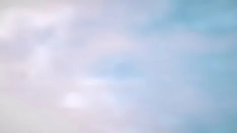 Soft pastel clouds drift gently in a seamless loop 動画素材 340957667