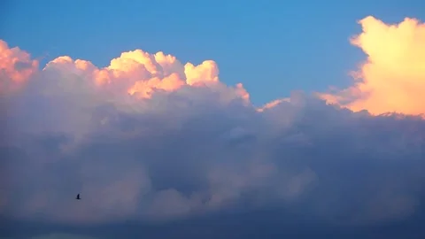 Soft pastel colors paint the sky as fluffy clouds gather, creating a captivating Stock Footage 310961287