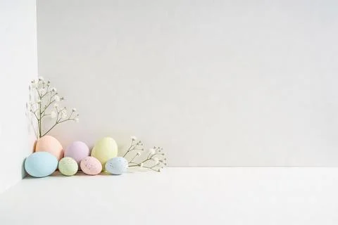 Soft pastel Easter eggs and delicate baby's breath flowers arranged in a corn Stock Photos