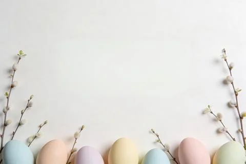 Soft pastel Easter eggs and pussy willow branches arranged on a clean white.. Stock Photos