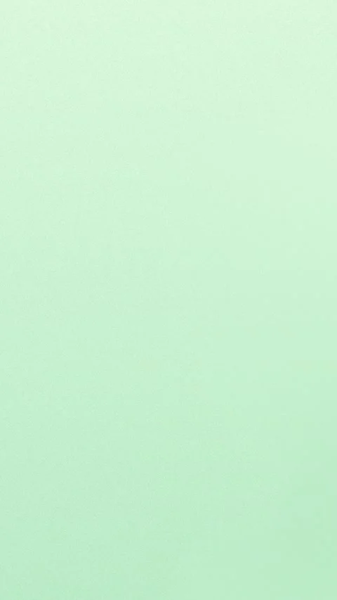 Soft pastel green seamless loop background with grain texture. 4K. Stockbeeldmateriaal 309856240