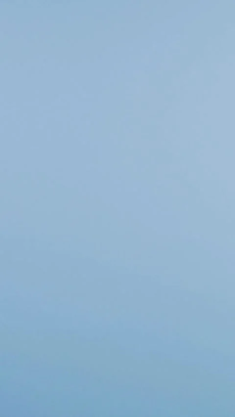 Soft pastel makeup sponges falling against light blue background 스톡 동영상 331781021