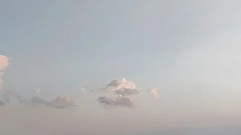 Soft Pastel Sky with Fluffy Clouds Sunset Background Stock Photos