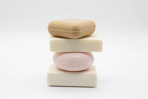 Soft pastel soaps stack neatly against clean white background Stock Photos