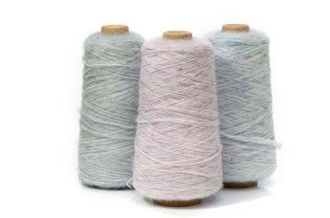 Soft pastel threads lined up, inviting creativity and inspiration in a warm.. Stock Photos