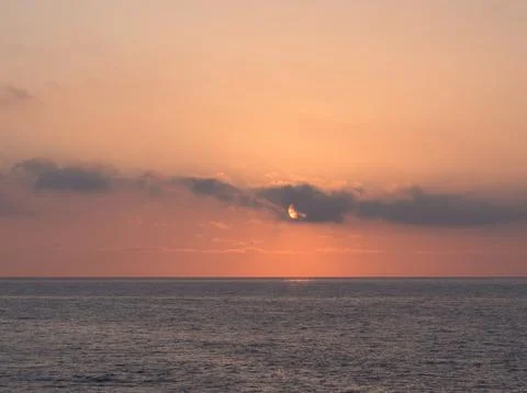 Soft Peach Sunset Over Ocean Horizon Silhouette - Tranquil seascape showing.. Stock Photos