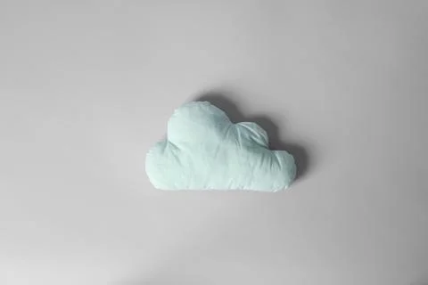 Soft pillow in shape of cloud on light background Stock Photos
