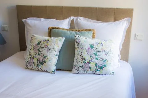 Soft pillows on a comfortable bed Stock Photos