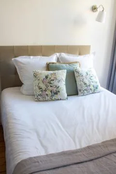 Soft pillows on a comfortable bed Stock Photos