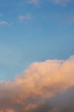 Soft Pink Clouds Against Blue Sky Фото