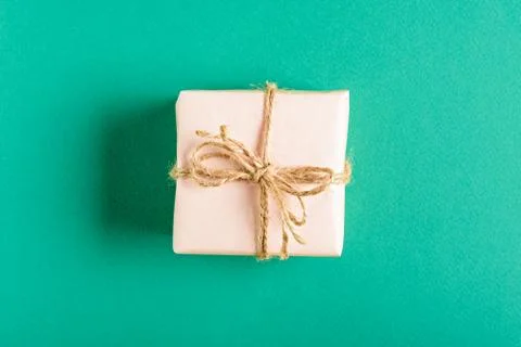 Soft pink gift box with bow on green background Stock Photos