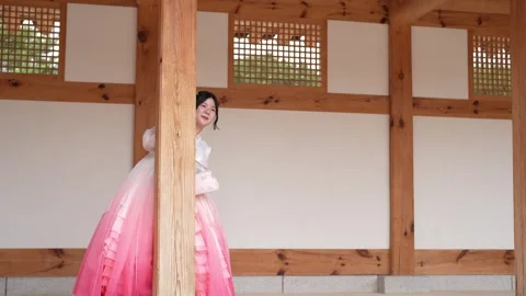 Soft pink gown drapes gently against wooden beams Stock Footage 340936616
