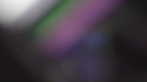 Soft pink, green and violet bokeh bands flowing across a dark gradient back.. Stock Footage 341324925