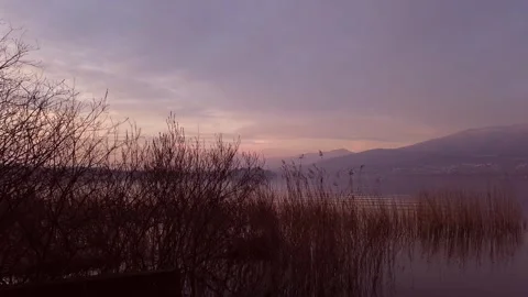 Soft Pink Sunset Reflecting Over Tranquil Lake Waters Stock Footage 329767965