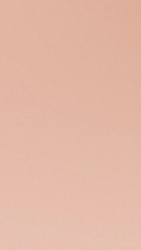 Soft pink textured background with a subtle gradient effect. Seamless loop in Stockbeeldmateriaal 309956626