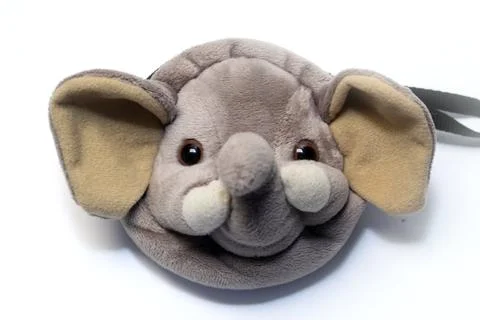 A soft plush pouch shaped like a cute grey elephant head with large ears an.. Stock Photos