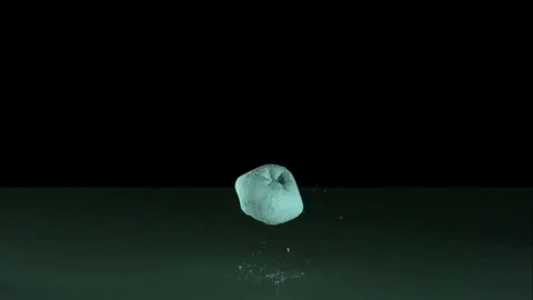 Soft powdered donuts falling and bouncing on reflective surface Stock Footage 327580644