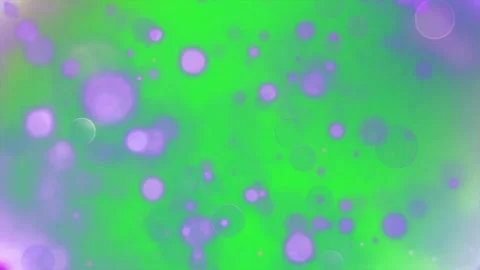 Soft purple bokeh light orbs drifting over vibrant green background Stock Footage 345216284