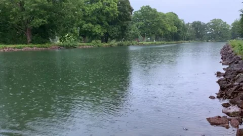 Soft Rain Falling Down on Water Canal River in Sweden, 4K Stock Footage 135470881
