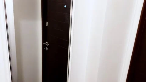 Soft Reflections at Dawn: Mirror Warmth in a Cozy Entryway Stock Footage 312866687