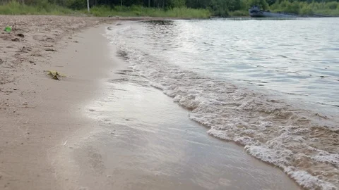 Soft, river wave with bubbles on a sandy beach 스톡 동영상 121829374