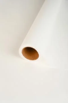 Soft roll of packaging paper in trending Cloud Dancer white  airy, minimal .. Stock Photos