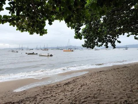 Soft sand beach on a cloudy day Stock Photos