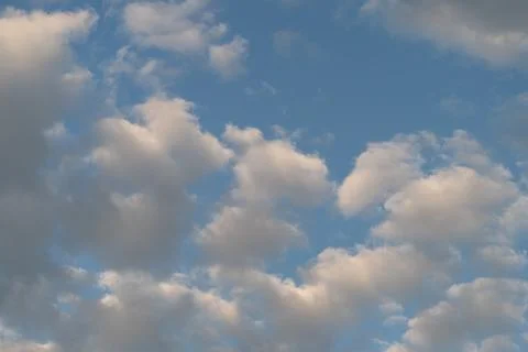 Soft scattered clouds over blue sky at golden hour Foto stock