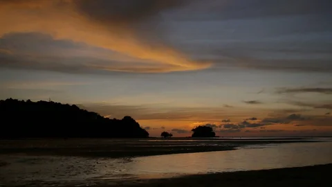 Soft sea wave breaking sand shore beach, silhouette mountain and island, clou Stock Footage 128295295
