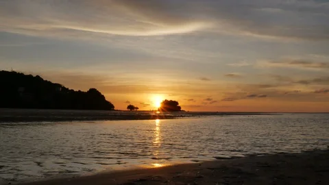Soft sea wave breaking sand shore beach, silhouette mountain and island,refle Stock Footage 128295542