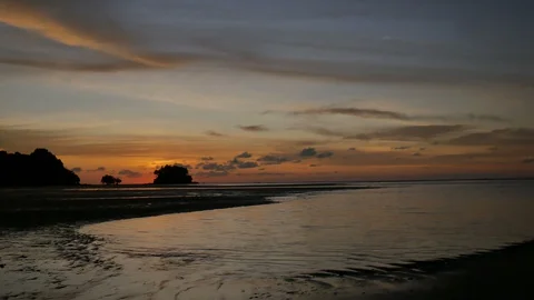 Soft sea wave breaking sand shore beach, silhouette mountain and island, clou Stock Footage 128295581