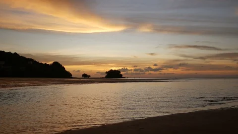 Soft sea wave breaking sand shore beach, silhouette mountain and island, airp Stock Footage 128295649